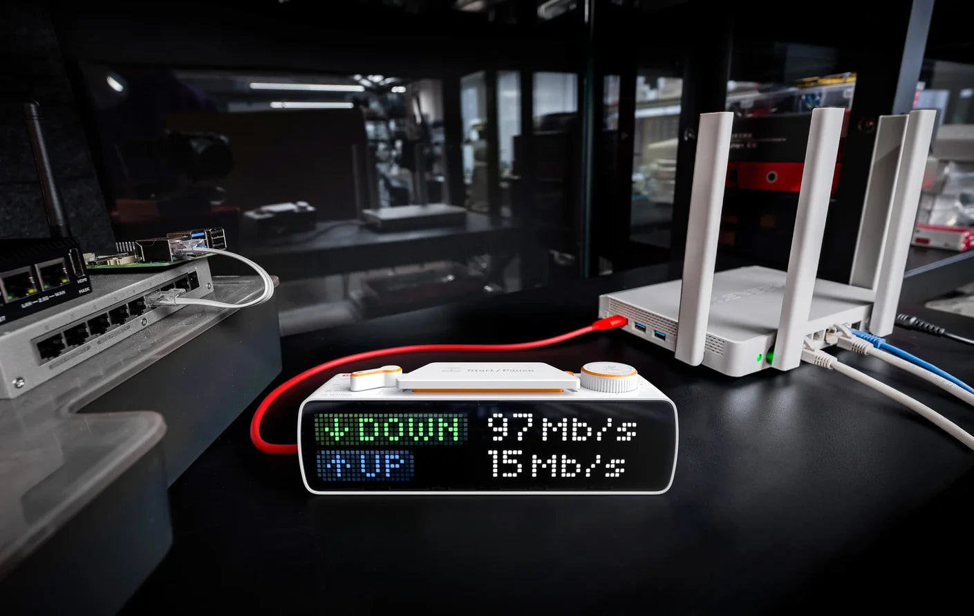 BUSY Bar showing internet speed test results — 97 Mb/s down, 15 Mb/s up — beside a router